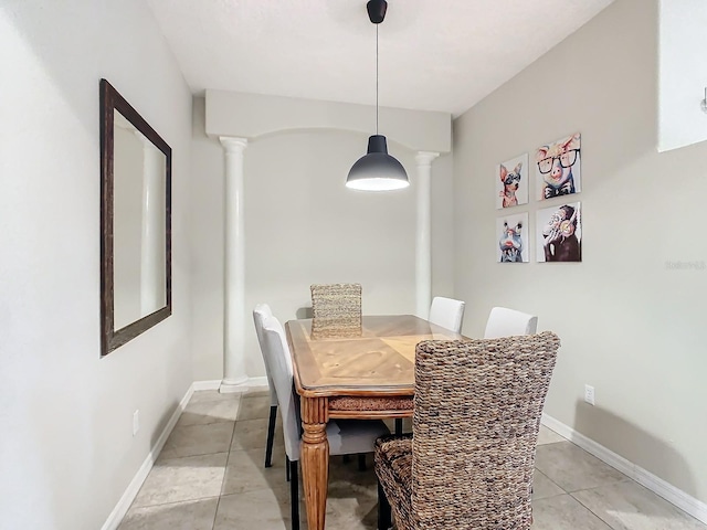 dining room with ornate columns and light tile patterned floors