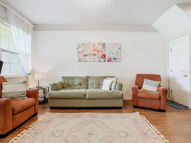 living room with lofted ceiling and hardwood / wood-style floors