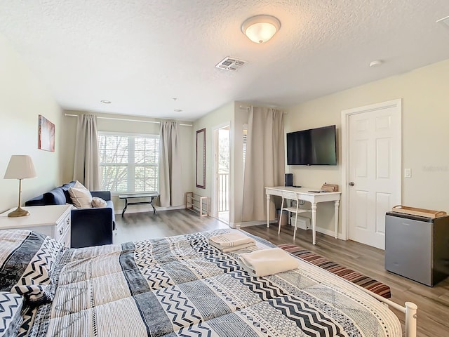 living room with a textured ceiling and hardwood / wood-style floors