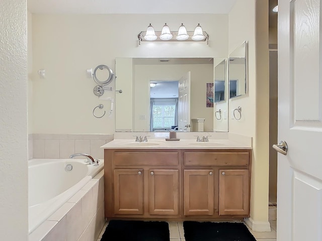 bathroom featuring vanity, a relaxing tiled tub, and tile patterned floors