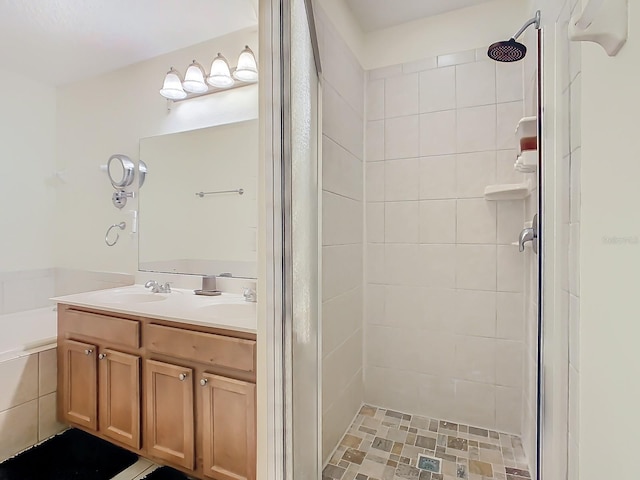 bathroom featuring vanity and tiled shower