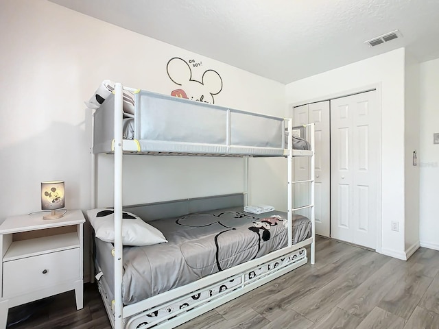 bedroom featuring a closet and wood-type flooring