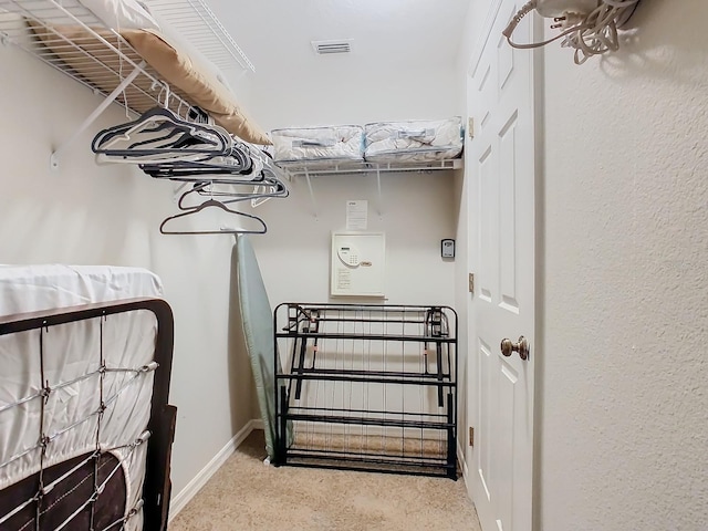 spacious closet featuring light carpet