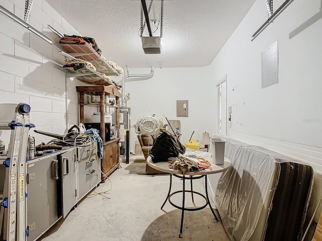 garage with a garage door opener, water heater, and electric panel