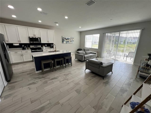 living room with light hardwood / wood-style flooring and sink