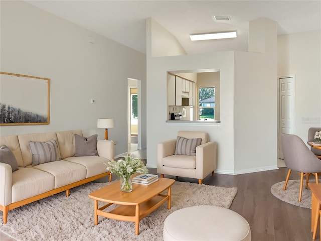 living room with hardwood / wood-style floors and vaulted ceiling