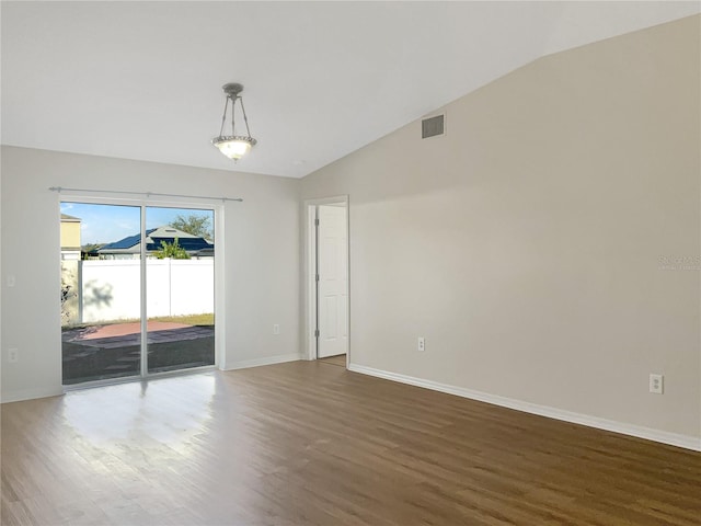 unfurnished room featuring dark wood-type flooring and vaulted ceiling