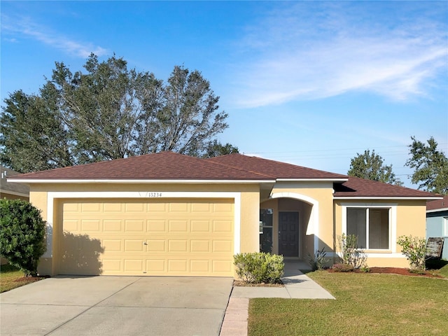 single story home with a front yard and a garage