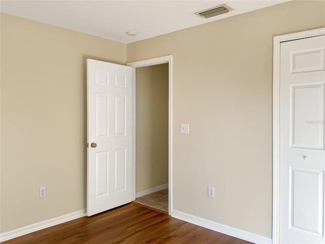 unfurnished bedroom with hardwood / wood-style flooring