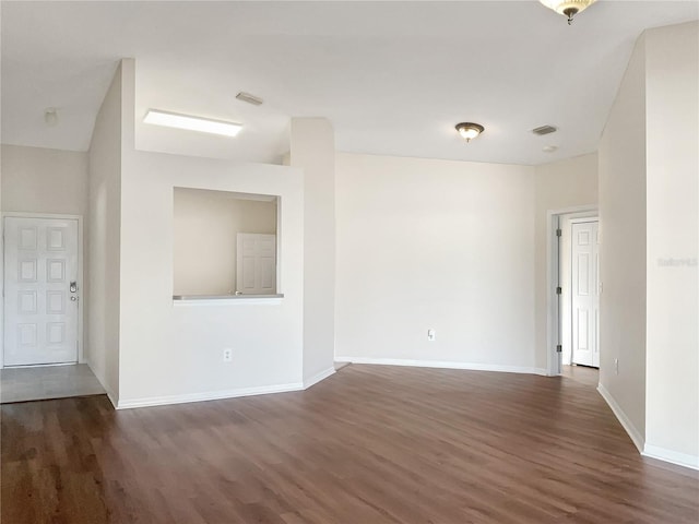 unfurnished room featuring dark wood-type flooring