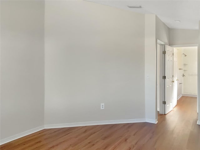 spare room with light wood-type flooring