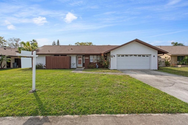 ranch-style home featuring a front lawn and a garage