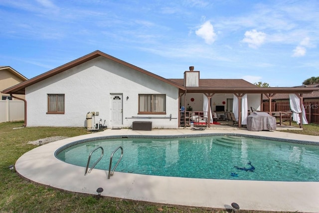 rear view of house with a patio area and a lawn