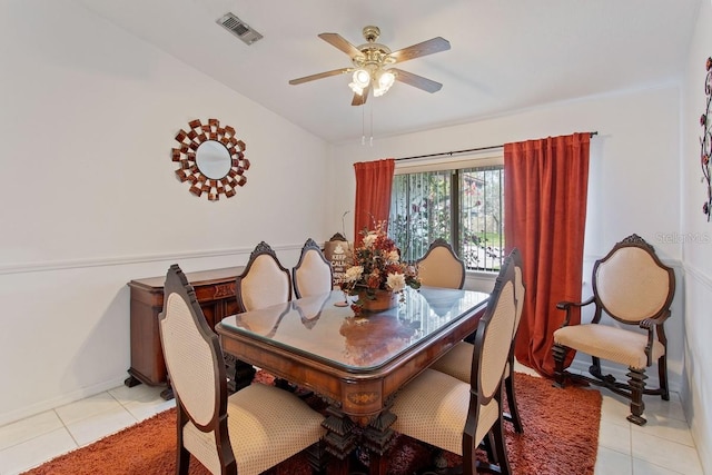 tiled dining space with ceiling fan