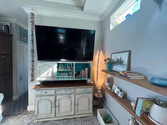 living room featuring ornamental molding and light wood-type flooring