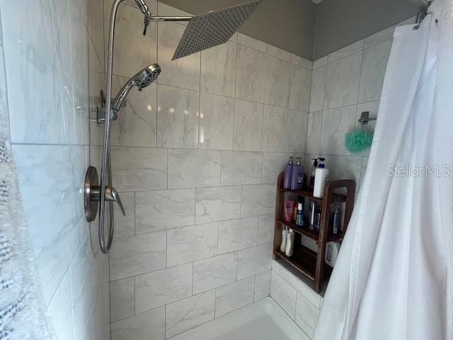 bathroom with tile walls and a shower with curtain