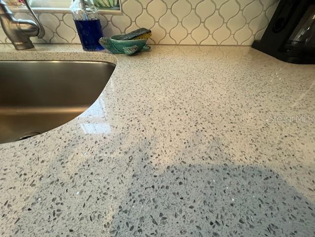 interior details with light stone counters and sink