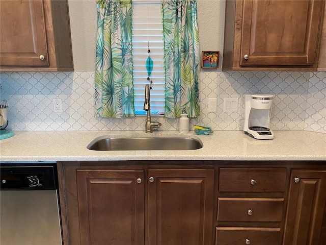 kitchen featuring backsplash, dark brown cabinetry, sink, and dishwasher