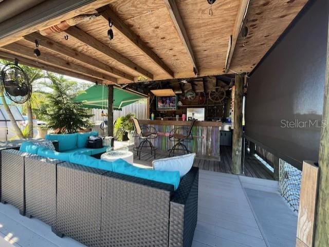 view of patio featuring an outdoor living space and a wooden deck