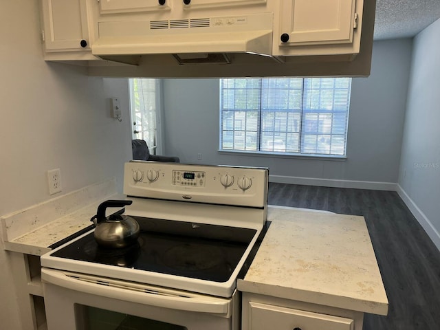 kitchen featuring white cabinetry, a textured ceiling, dark hardwood / wood-style floors, and white electric range oven