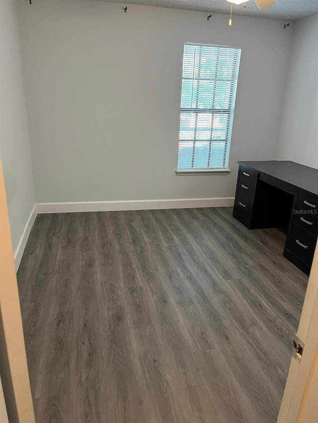 spare room featuring a textured ceiling, dark hardwood / wood-style flooring, and ceiling fan