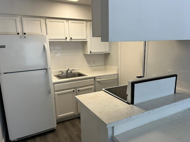 kitchen featuring white refrigerator, white cabinets, sink, dishwasher, and dark wood-type flooring