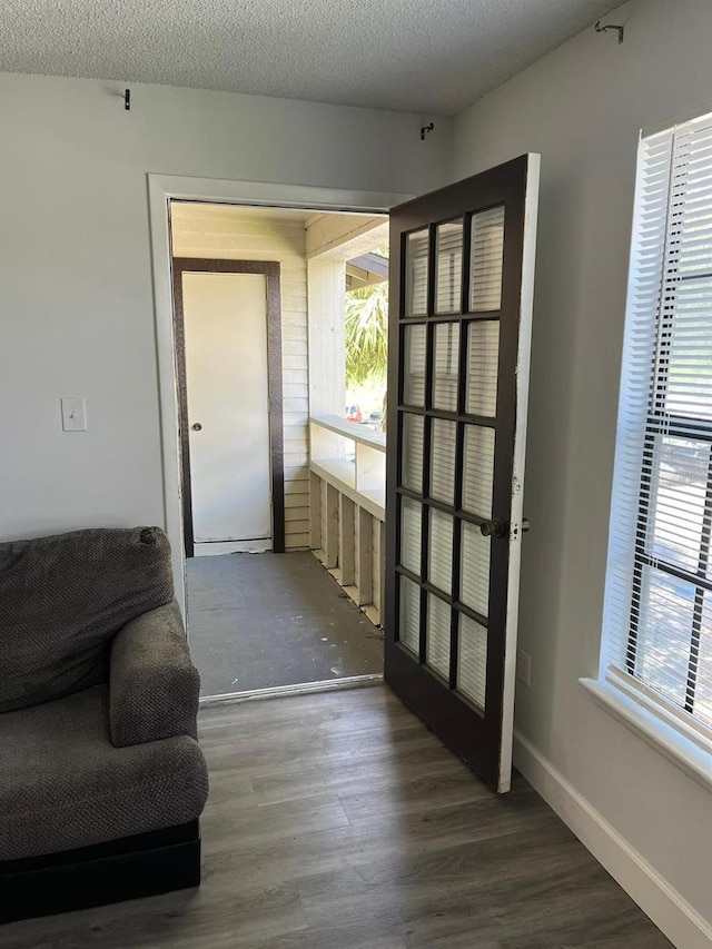 doorway to outside featuring hardwood / wood-style floors and a textured ceiling