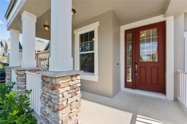 view of exterior entry with covered porch