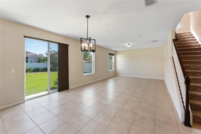 interior space featuring a wealth of natural light, a notable chandelier, and light tile patterned floors