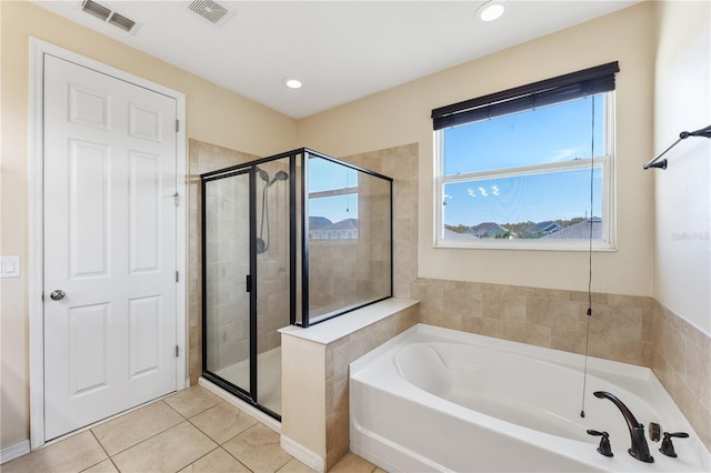 bathroom with tile patterned floors and independent shower and bath