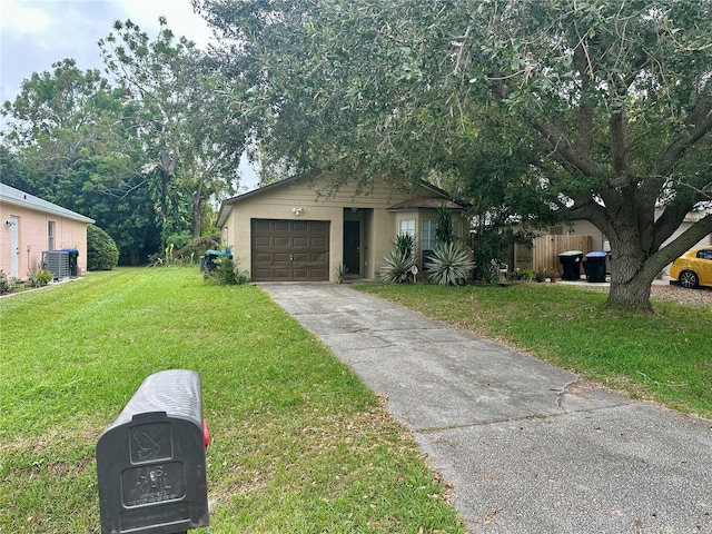 view of front of home with a front yard, a garage, and cooling unit