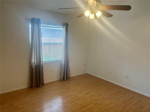 empty room featuring light hardwood / wood-style floors, a textured ceiling, and ceiling fan