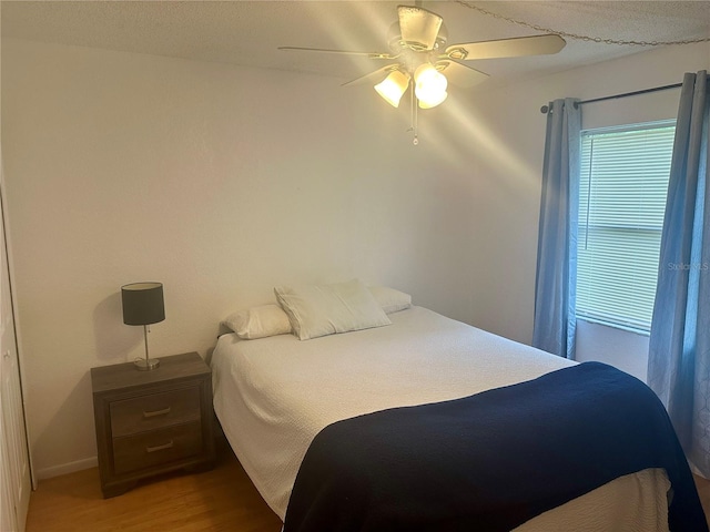 bedroom featuring wood-type flooring and ceiling fan