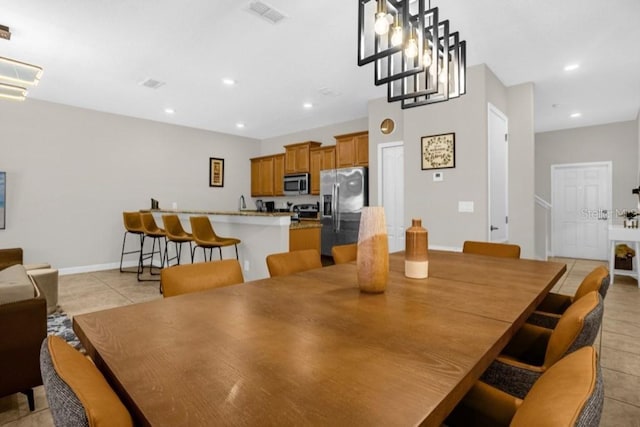 dining room featuring light tile patterned floors and an inviting chandelier