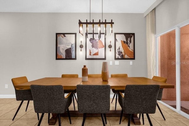 dining space with a notable chandelier and light tile patterned floors