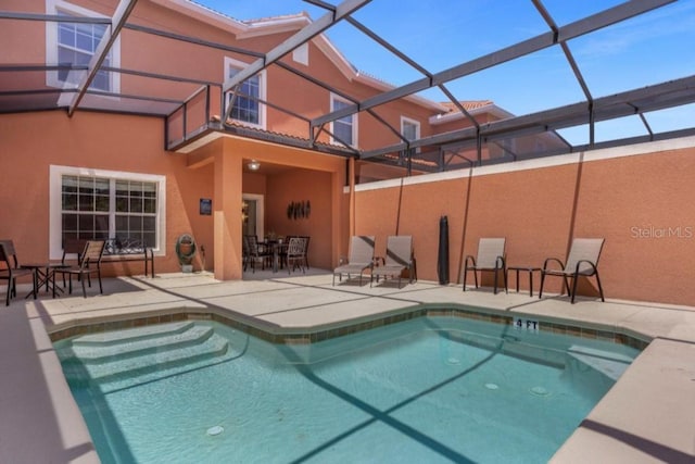 view of pool with a patio area and a lanai