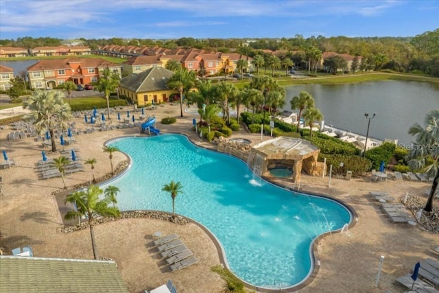 view of swimming pool with a water view and a patio area