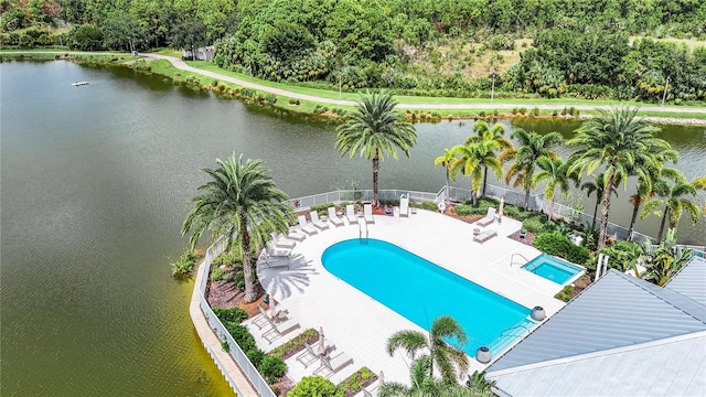 view of pool featuring a water view and a patio