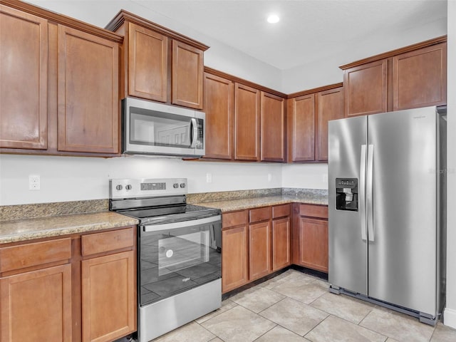 kitchen with stainless steel appliances, recessed lighting, light tile patterned flooring, and brown cabinets