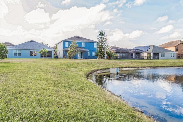 exterior space featuring a lawn and a water view