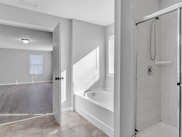 full bathroom with a stall shower, visible vents, a bath, and tile patterned floors