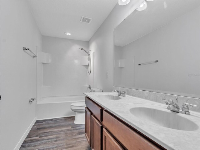 bathroom featuring visible vents, a sink, shower / bathtub combination, and double vanity