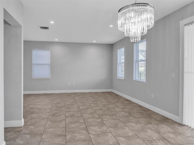 unfurnished room with a notable chandelier, light tile patterned floors, recessed lighting, visible vents, and baseboards