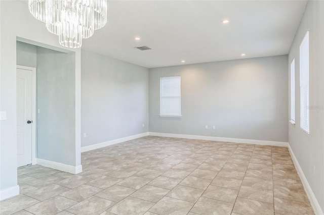 unfurnished room with baseboards, recessed lighting, visible vents, and an inviting chandelier