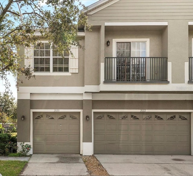 view of front of property with a balcony and a garage