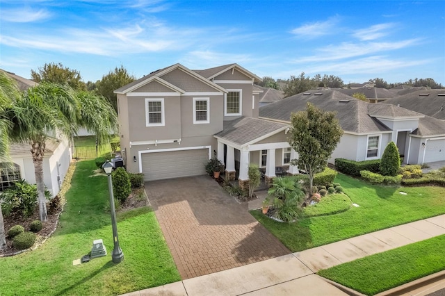 view of front of property with a front yard and a garage