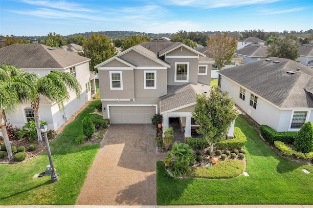 view of front of home featuring a garage and a front lawn