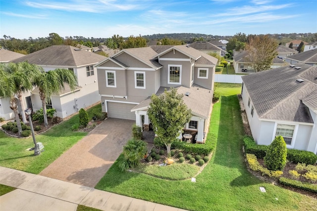 view of front of house featuring a front lawn and a garage