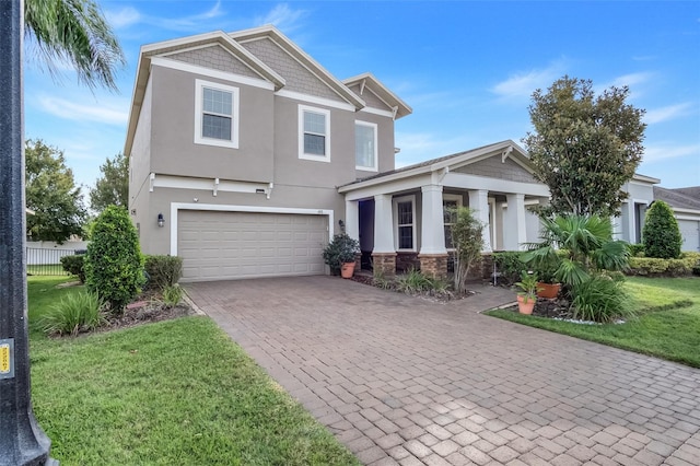 view of front of home featuring a front yard and a garage