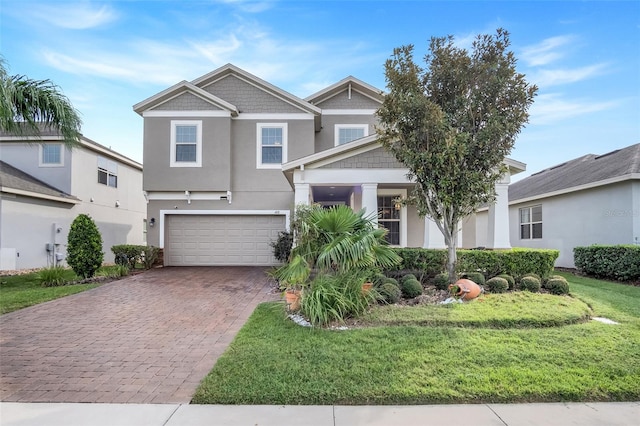 view of front facade with a front yard and a garage